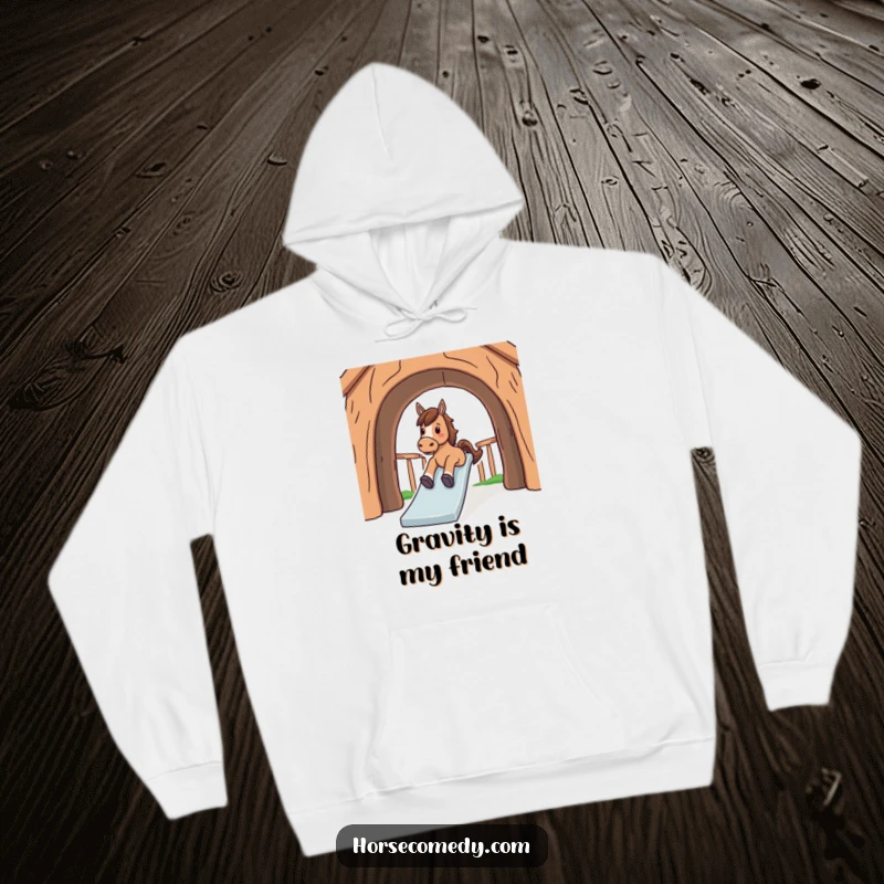 Funny hoodie featuring a horse having a blast sliding down a bright, large, arched structure with a smile.