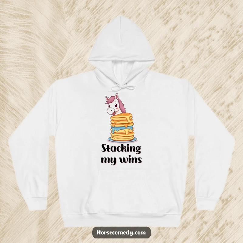 Funny horse hoodie with a delighted horse character balancing a colorful, precarious stack of wobbling pancakes, looking pleased.