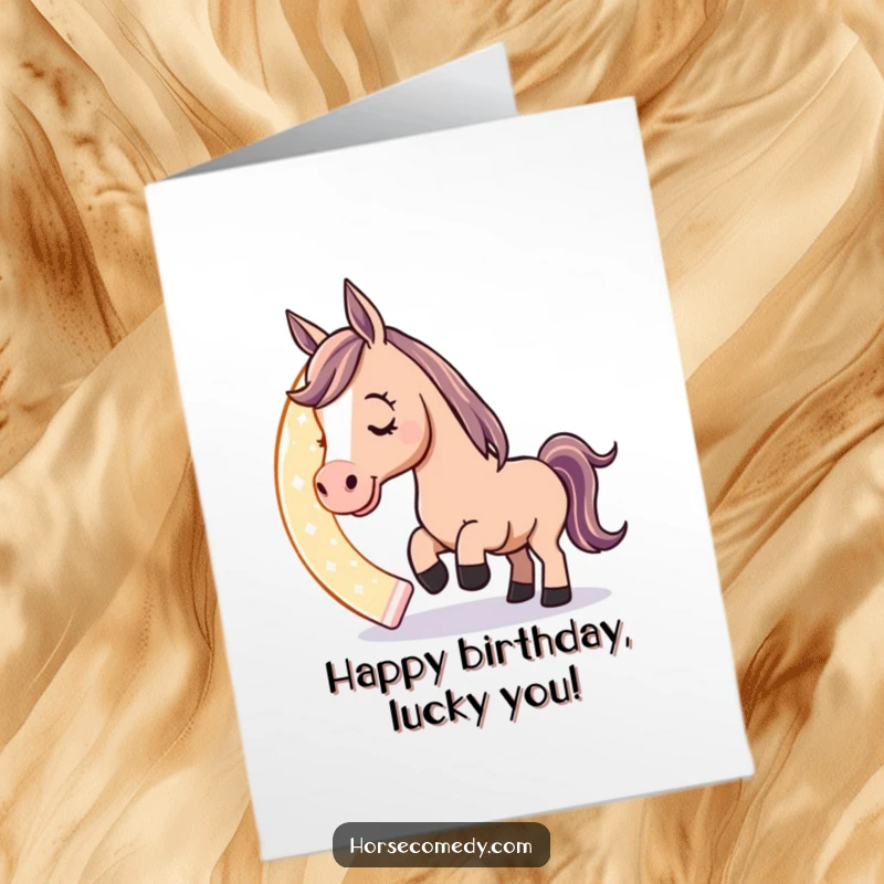 Funny Free Printable Birthday Card: A horse character playfully nudges a giant, glowing horseshoe with its nose, symbolizing good luck and charm.